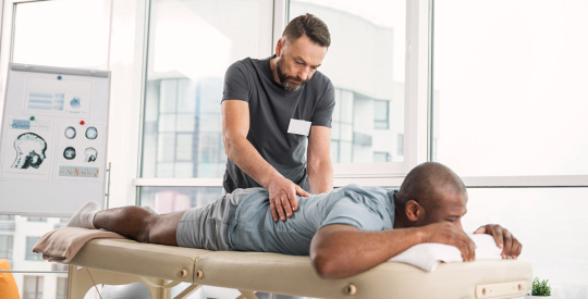 man doing physical therapy of his client